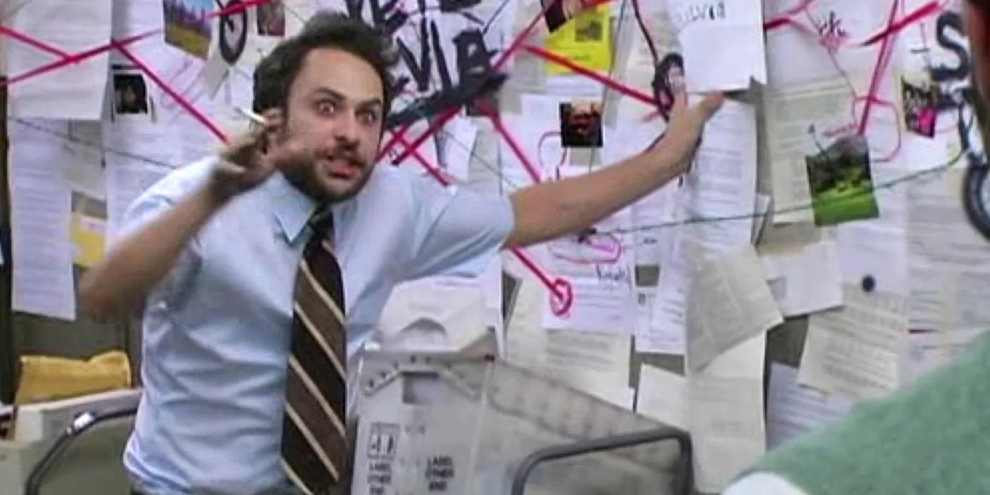 Charlie Day gesturing wildly at a wall of pinned papers connected by red string